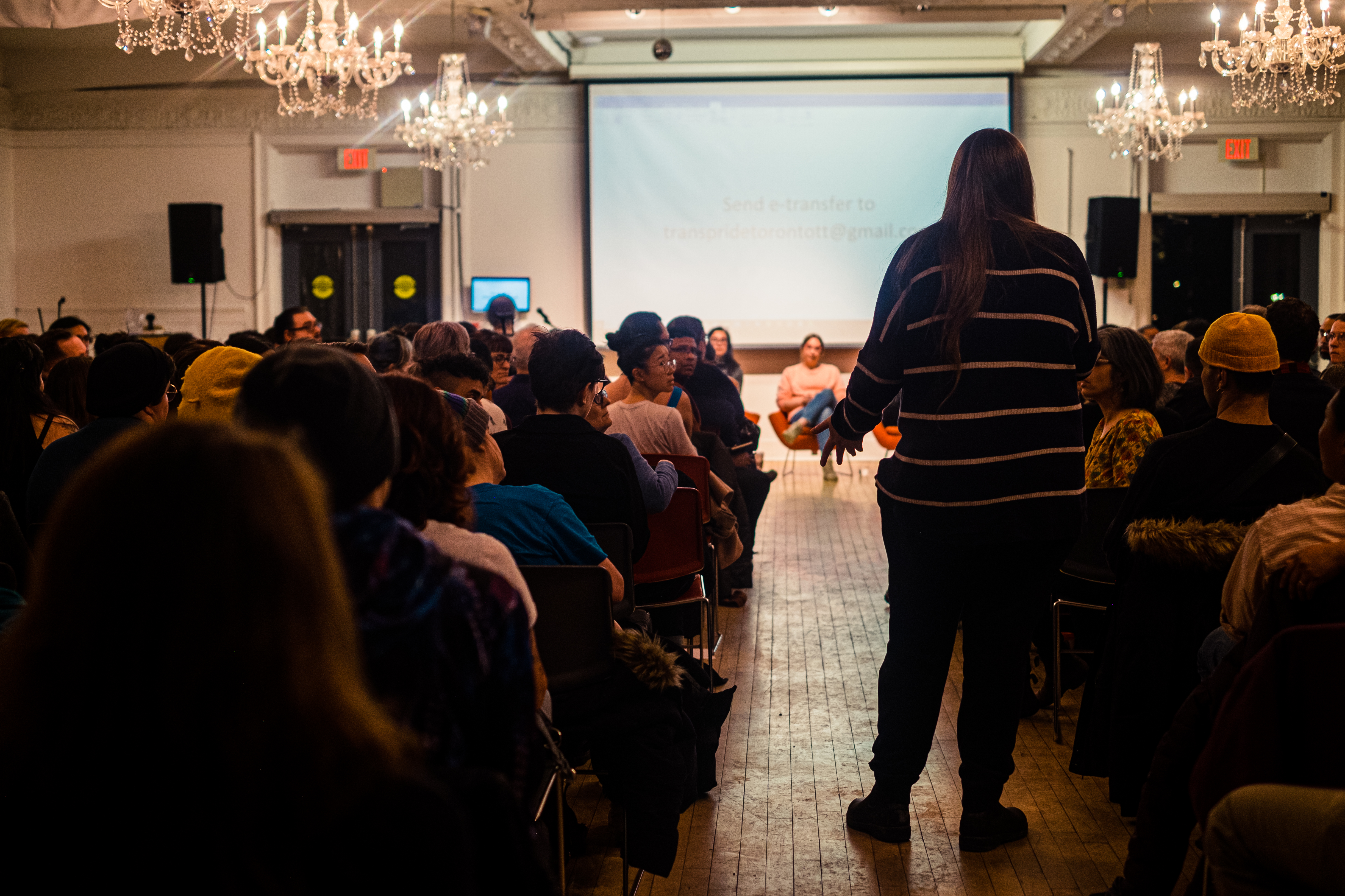 A person from the audience interacting with the panelists